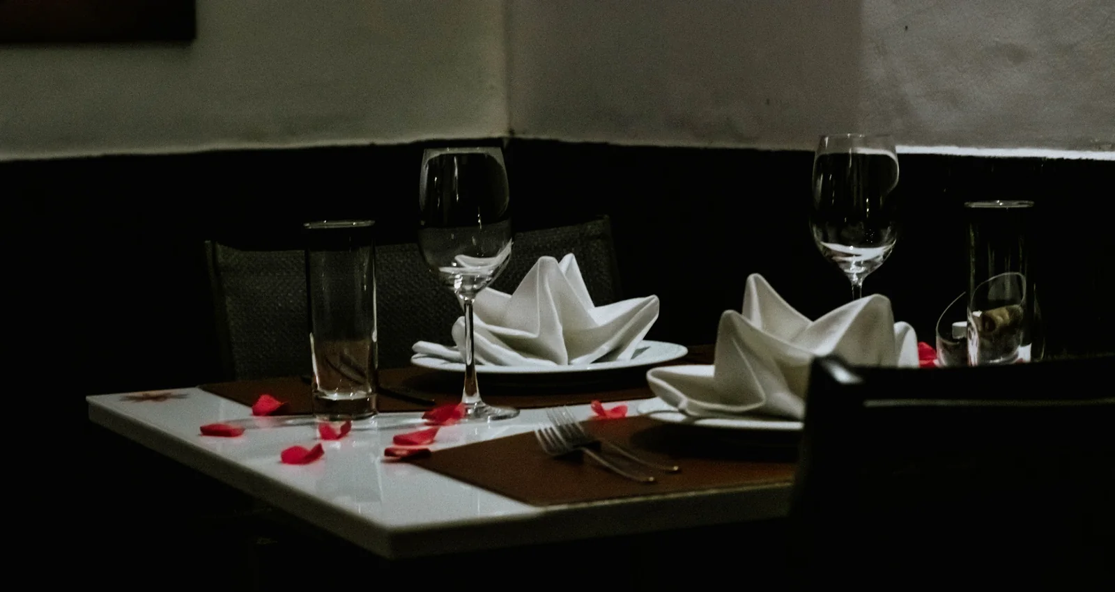 Table set for dinner with wine glasses and folded napkins